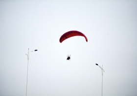 10月25日下午，動力傘從一對路燈上空飛過