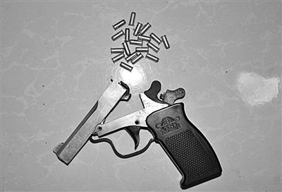 警方從搶劫嫌疑人處起獲的贓款和發(fā)令槍、子彈。警方供圖