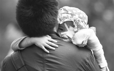 昨日，北京同仁醫(yī)院，被砍傷的彤彤趴在舅舅的肩上。他們剛剛掛完號，正準備回旅館。新京報記者 尹亞飛 攝