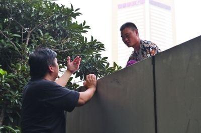 黃主任站在獨木樁上與男子交談了近半小時。