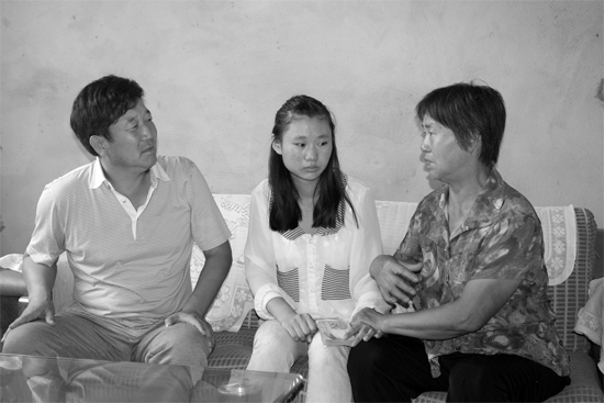 “商丘最美女兒”李丹（中）捐骨髓救母，愛心人士（左）送來1萬元愛心款