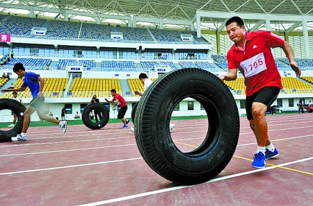 8月15日，運(yùn)動(dòng)員們正在進(jìn)行推輪胎賽跑。