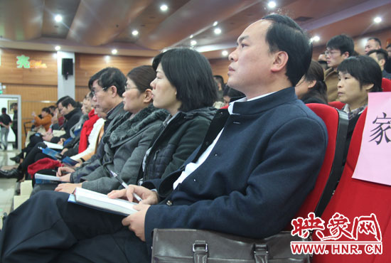 認(rèn)真聽(tīng)取招生政策的學(xué)生家長(zhǎng)。