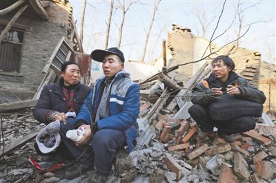 2014年1月，取保候?qū)彽乃螤?zhēng)光和父母看著殘敗的房子，默默流淚