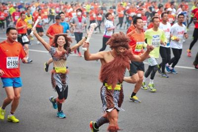 “原始人”打扮的參賽者向觀眾揮手。